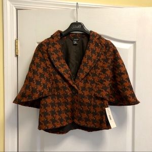 Jacket/poncho w/orange & black houndstooth pattern